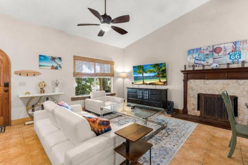 a living room with a white couch and a fireplace at The Sebastian Surf Lodge in Vero Beach