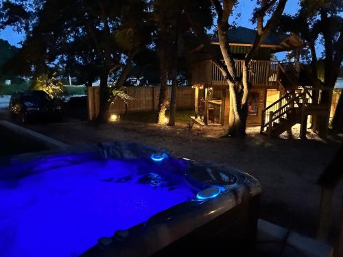 a jacuzzi tub in a yard at night at The Sebastian Surf Lodge in Vero Beach