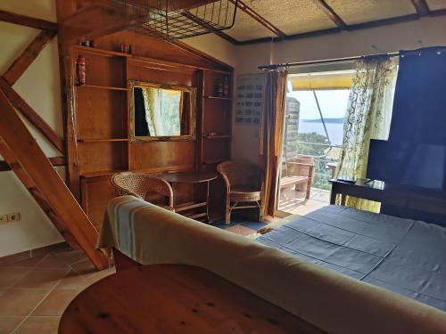 a bedroom with a bed and a table and a window at Villa Sofia in Marmari