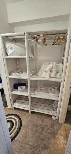 a closet with white shelving in a room at 3 SENSES villa in Dhriopís