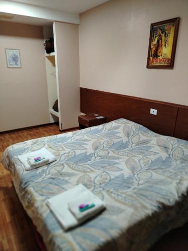 a bedroom with a bed with two towels on it at Hotel Nerja in San Juan