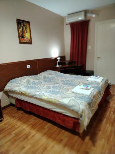 a bed in a bedroom with a wooden floor at Hotel Nerja in San Juan