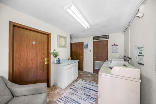 an office with a couch and a table and a room at Wanderlust Studio Suite with Private Patio in Harrison Hot Springs