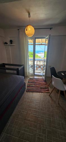 a bedroom with a bed and a view of the ocean at 3 SENSES villa in Dhriopís
