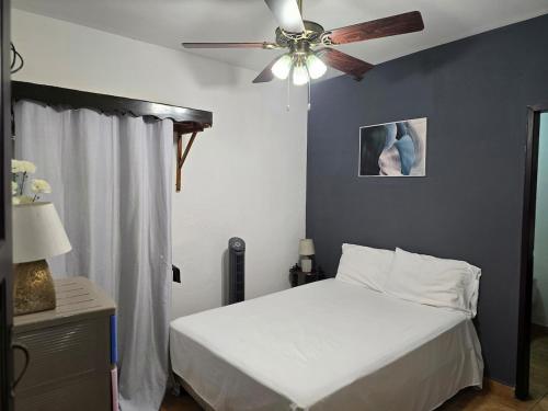 a bedroom with a bed and a ceiling fan at Modern House with Private Pool in Santa Rosa de Copán