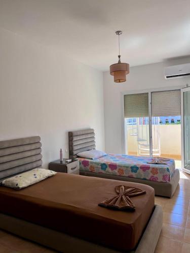 two beds in a room with two beds sidx sidx sidx at Luxueuse à Marina Saidia in Saïdia