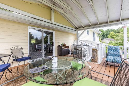 a patio with a glass table and chairs at Mountain Forest Manor in Hiawassee