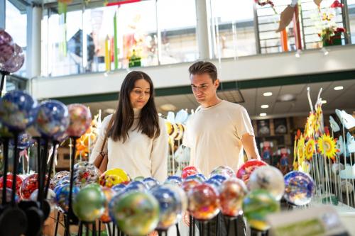 a man and a woman looking at balloons in a store at Landal Arber in Zwiesel