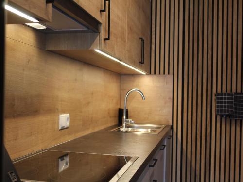 a kitchen with a sink and a counter top at Modern apartment in the Tyrolean mountains in Fliess