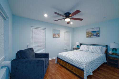 a bedroom with a bed and a ceiling fan and a chair at Dolphin Retreat in Brunswick