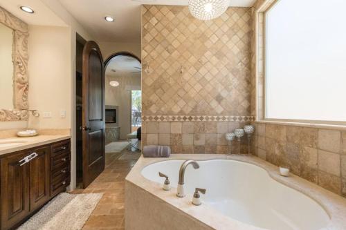 a large bathroom with a tub and a window at Bella Sirena Villa 8 - Your Dream Coastal Escape in Puerto Peñasco
