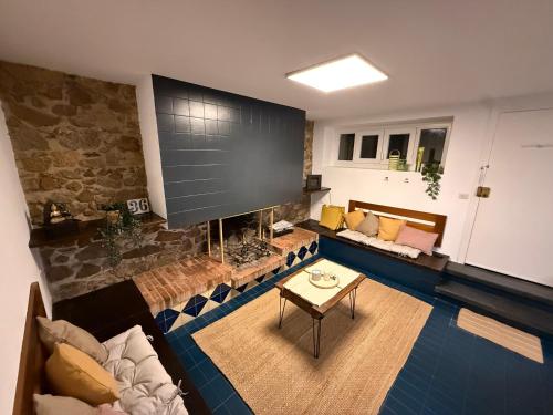 a living room with a fireplace and a large screen at Casa con encanto en Darnius in Darnius