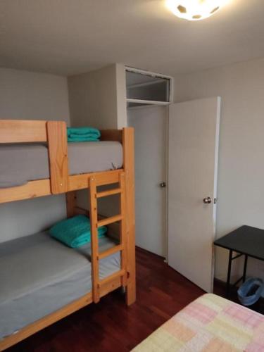 a bedroom with two bunk beds and a closet at Blue Coast Lima private rooms Peru in Lima
