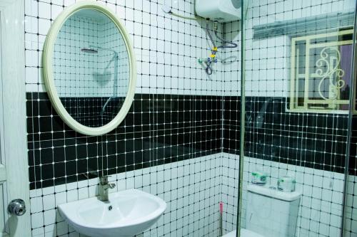 a bathroom with a sink and a mirror at Elite Gold Luxury Hotel in Abuja