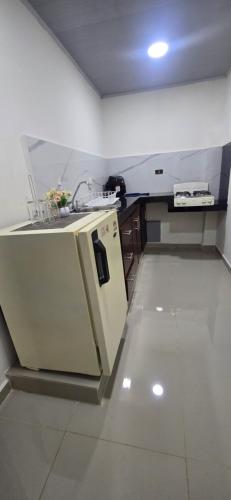 a white kitchen with a sink and a counter at Cerete Apartment 111 in Cereté