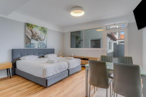 a bedroom with a bed and a table and chairs at Villa Winter Apt 1 in Funchal
