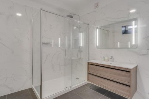 a white bathroom with a shower and a sink at Villa Winter Apt 1 in Funchal