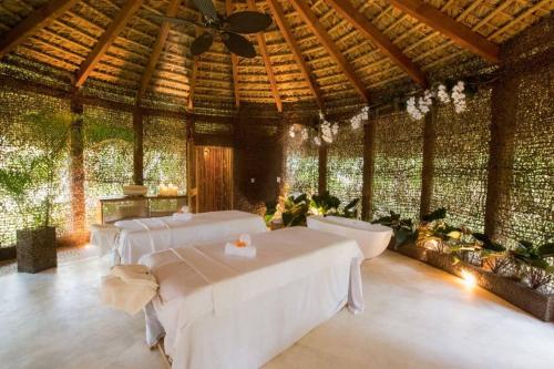 a large room with white tables and a ceiling at Sublimeluxcondo Terrenas Jaccuzibeachfront in Las Terrenas
