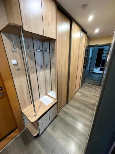 a locker room with wooden walls and a wooden floor at Klaipeda City in Klaipėda