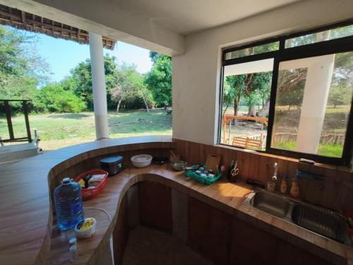 a kitchen with a bath tub and a sink at Seasoul Sanctuary in Shimoni