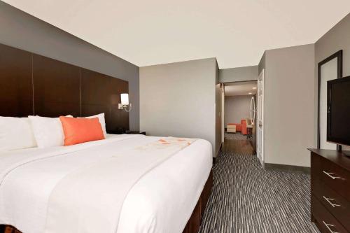 a hotel room with a large bed and a flat screen tv at Hawthorn Extended Stay by Wyndham Columbus West in Columbus
