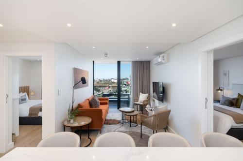a hotel room with a bedroom and a living room at Newlands Peak Luxury Suite in Cape Town