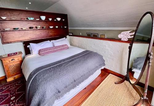 a small bedroom with a bed in a boat at Love Nest In Pringle Bay in Pringle Bay