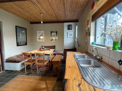a kitchen with a table and a sink in a room at Love Nest In Pringle Bay in Pringle Bay