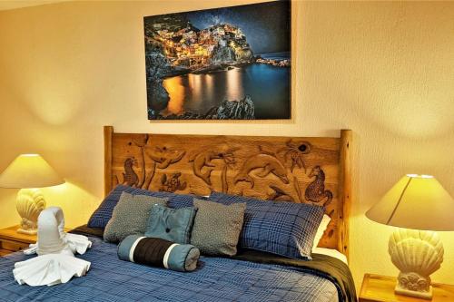 a bedroom with a bed with a large wooden headboard at Sonoran Spa 304-N in Puerto Peñasco
