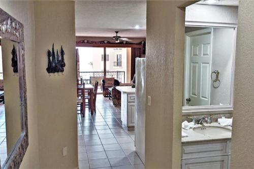 a kitchen with a sink and a refrigerator in a room at Sonoran Spa 304-N in Puerto Peñasco