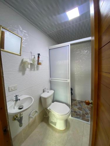 a bathroom with a toilet and a sink at La posada in Nuquí