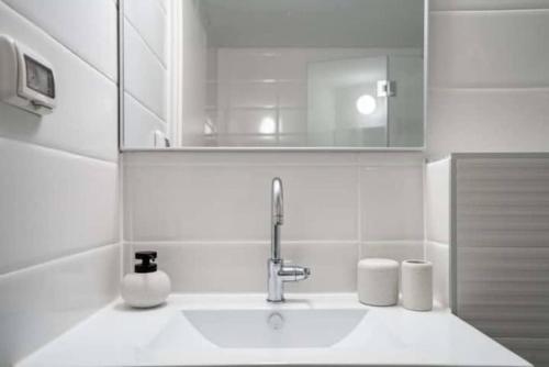 a bathroom with a sink and a mirror at 1 Br Apartment In Shaul Adler in Jerusalem