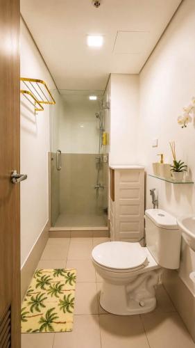 a bathroom with a toilet and a shower and a sink at LuxeInn in Trece Martires