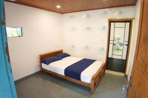 a bedroom with a bed in a room with a window at Glen Brooks Resorts in Calicut