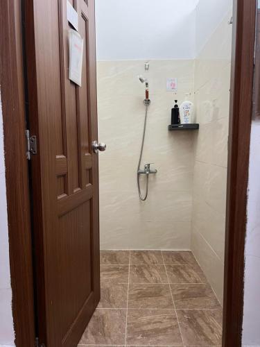 a bathroom with a shower with a shower head at Usagiyah Hotel & Guest House in Ho Chi Minh City