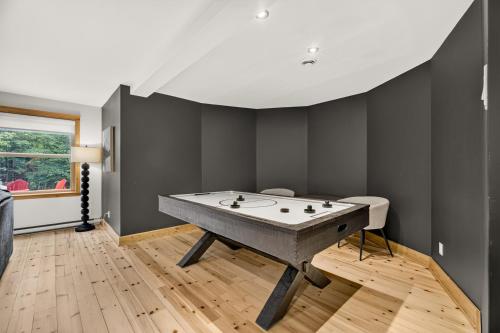 a ping pong table in a room with black walls at Fiddler Lake Resort - Deer 47 in Mille-Isles