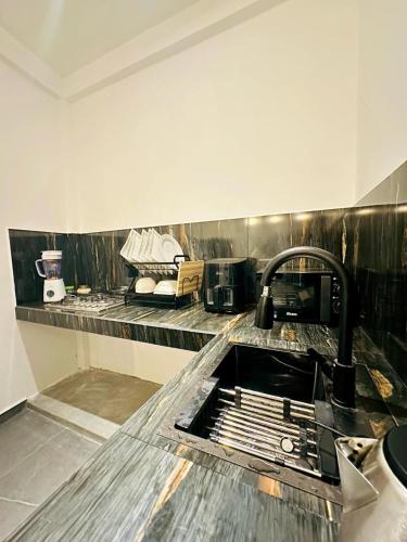 a kitchen with a sink and a counter top at The Elm in Weligama
