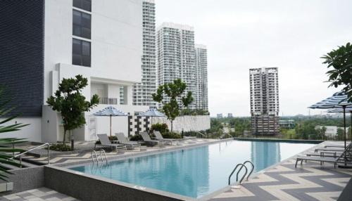 a swimming pool on the roof of a building at OZO Medini Malaysia in Nusajaya