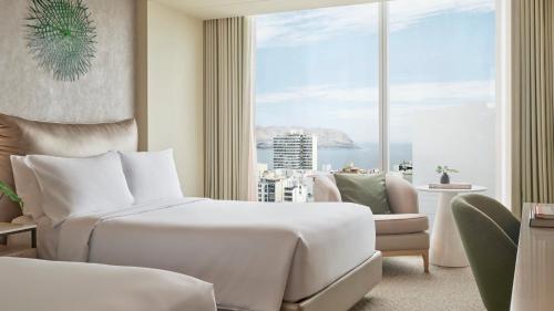 a hotel room with a bed and a large window at SOUMA Hotel, Vignette Collection by IHG in Lima