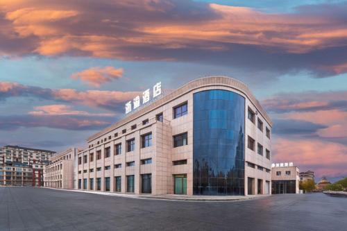 a building with a sign on the top of it at BOLE ZHEYU Hotel in Bole