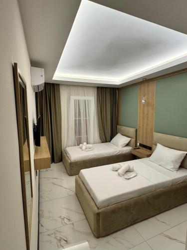 a hotel room with two beds in a room at Ydora Luxury Hotel in Bodrum City