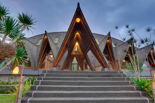 a building with stairs in front of it at Plaga Eco Village by Nabe Hospitality Management in Plaga
