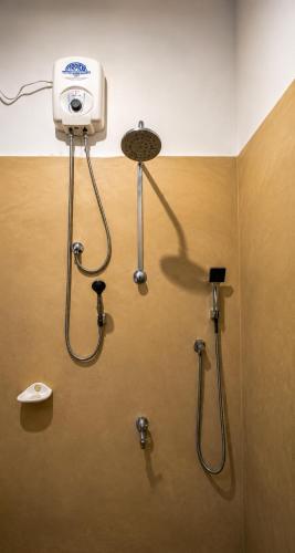 a bathroom with a shower with a camera on the wall at Sinharaja Forest Lodge - Deniyaya in Dombagoda
