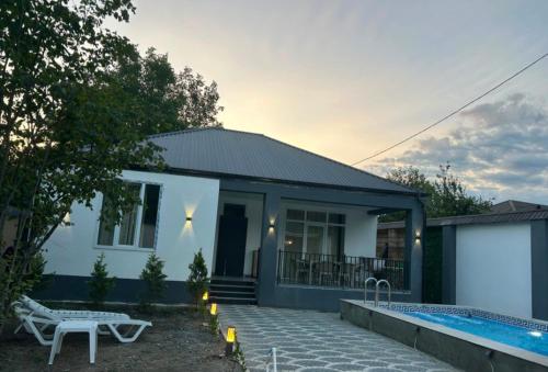 a house with a swimming pool in front of it at Rewad villa in Gabala