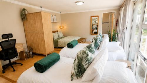 a room with three beds and a television and a bedroom at Joy Haven - Open Plan Studio in Centurion