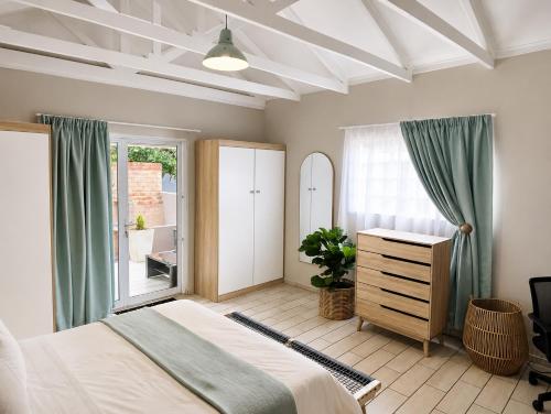 a bedroom with a bed and a dresser and a window at Joy Haven - Cottage in Centurion