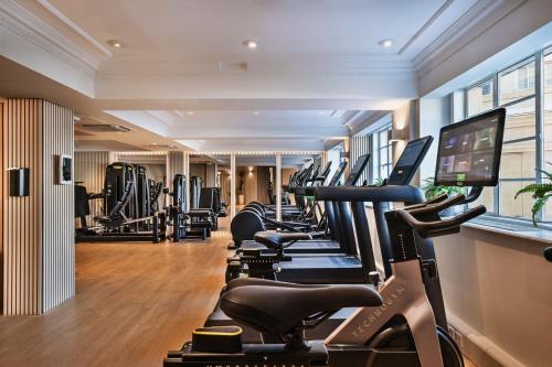 a gym with treadmills and elliptical machines at Meliá White House in London