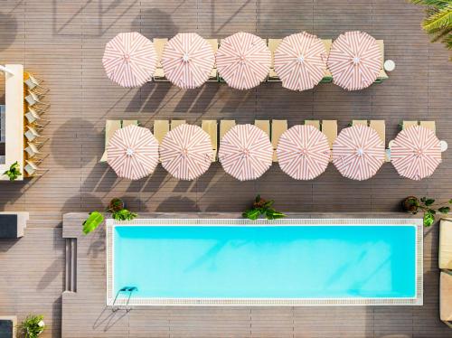 a group of umbrellas on a wall next to a swimming pool at SOL by Meliá House Mallorca - Adults Only in Magaluf