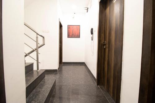 a hallway with a door and stairs in a building at Hotel O Sai Plaza in Aurangabad