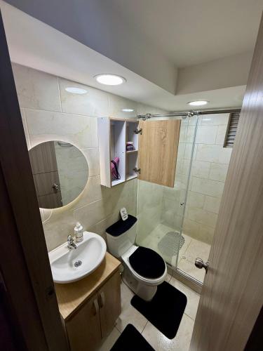 a bathroom with a toilet and a sink and a shower at Fly At Home Bogotá in Bogotá